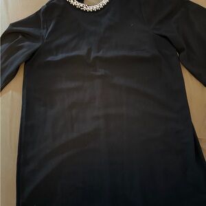 Elegant Black Dress with Pearl Necklace
